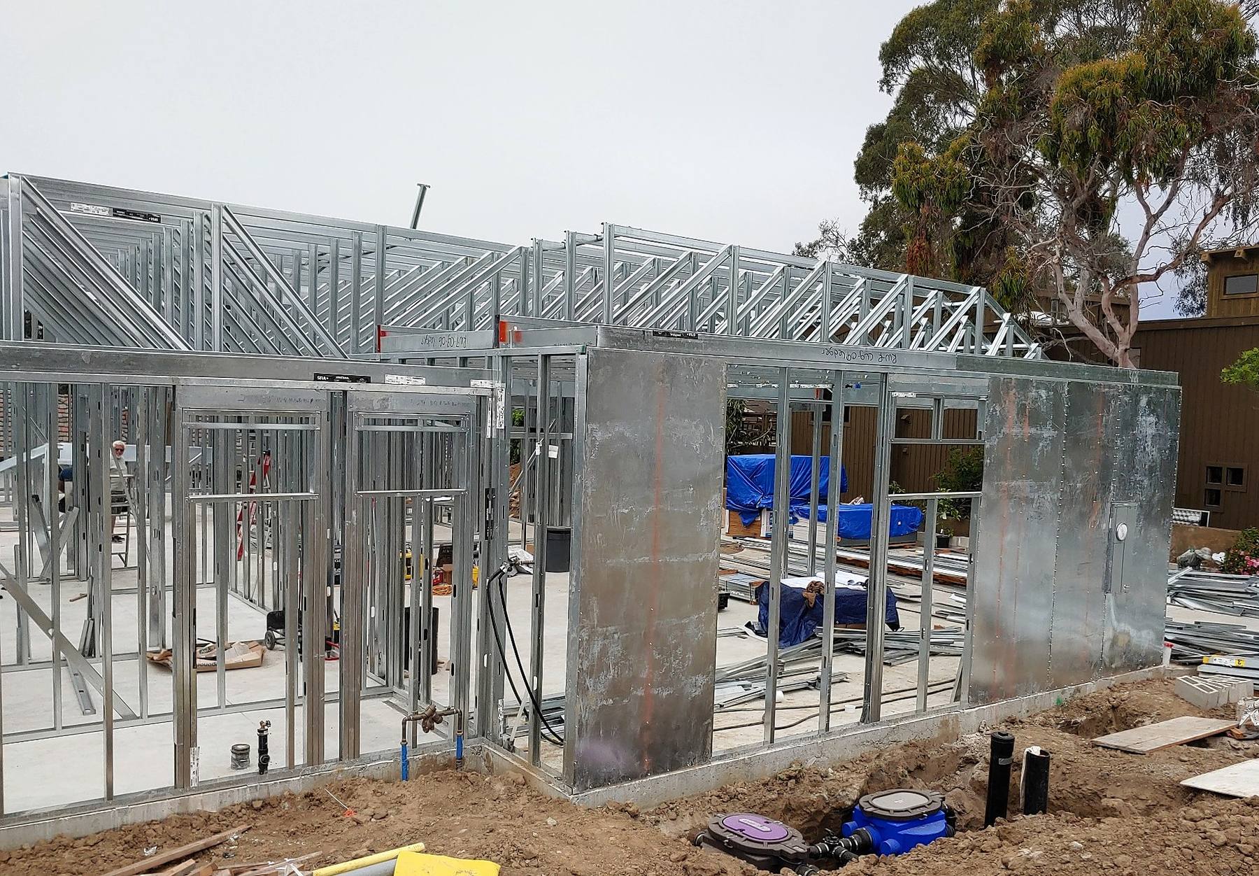 Residential cold-formed steel wall and roof truss framing under construction.