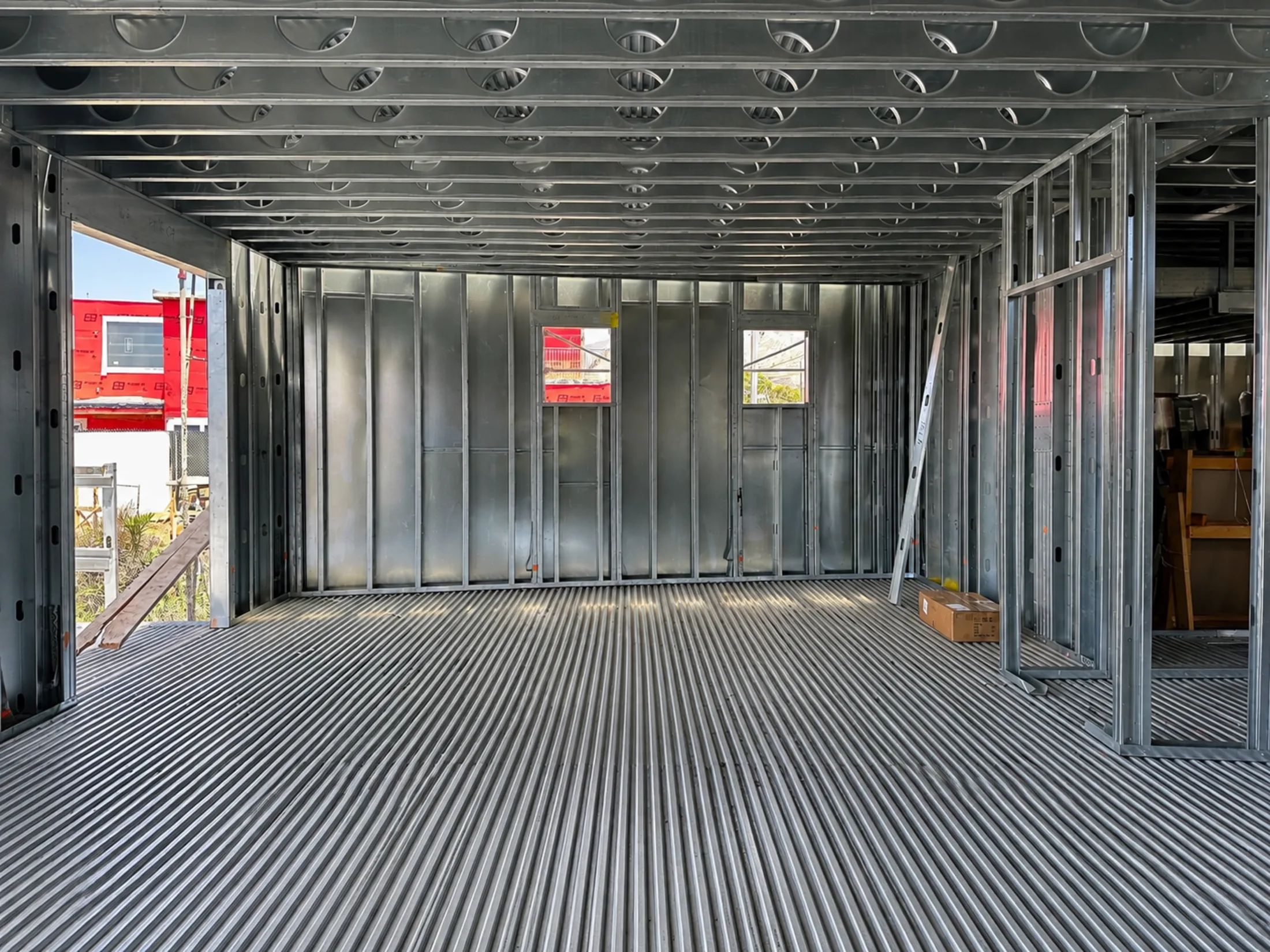 Interior of the Pacific Palisades rebuild showing residential cold-formed steel framing: wall studs, ceiling joists and steel decking