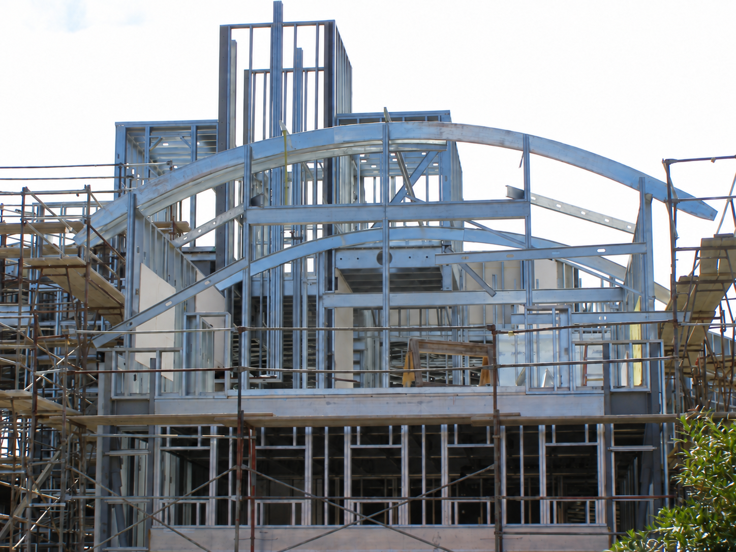 Arched and curved cold-formed steel roof framing on a residence under construction