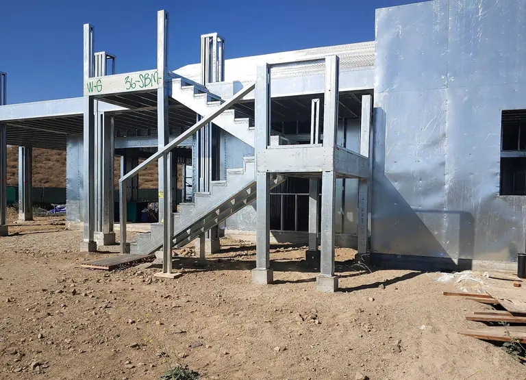Custom residential steel stair and surrounding cold-formed steel framing.